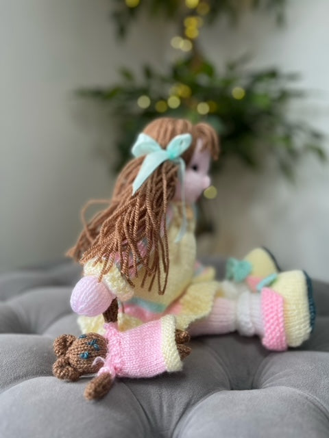 Hand Made Knitted Girl Doll with Brown Hair Yellow Dress Holding a Toy Oh So Crafty